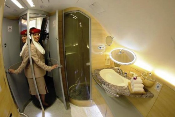 A stewardess poses inside a Emirates A380 bathroom.